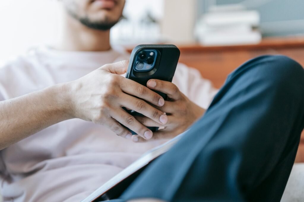 a man using his phone to transfer deposit